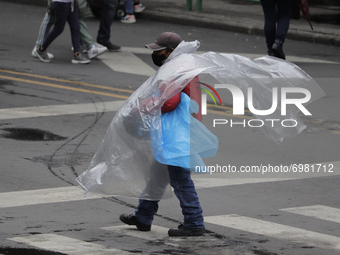 A seller of plastic sheeting in the Historic Centre of Mexico City offers his products after rains and strong gusts of wind due to Hurricane...