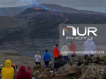 People watch the eruption of the volcano Geldingadalir  from Fagradalsfjall on Thursday, August 19, 2021.
The fissure eruption began Friday...