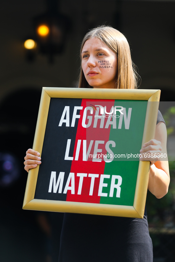 A woman holds a banner 'Afghan Lives Matter' during a protest In Solidarity With Afghanistan in front of the U.S. Consulate General in Krako...