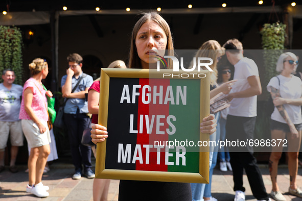 A woman holds a banner 'Afghan Lives Matter' during a protest In Solidarity With Afghanistan in front of the U.S. Consulate General in Krako...