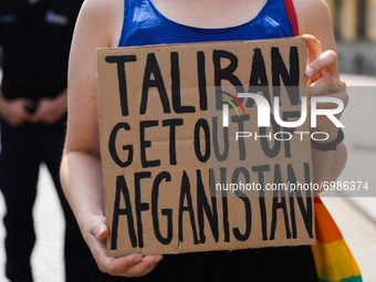 A demonstrator holds a banner 'Taliban Get Out Of Afganistan' during a protest In Solidarity With Afghanistan in front of the U.S. Consulate...