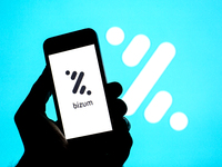 In this photo illustration a Bizum logo seen displayed on a smartphone with a Bizum logo in the background. (