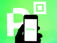 In this photo illustration a PicPay logo seen displayed on a smartphone with a PicPay logo in the background. (