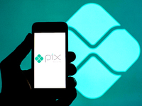 In this photo illustration a Pix logo seen displayed on a smartphone with a Pix logo in the background. (