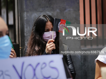A woman holds an Afghanistan flag to protest on August 23, 2020 in Mexico City, Mexico. Women protest outside the Secretaria de Relaciones E...