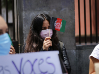 A woman holds an Afghanistan flag to protest on August 23, 2020 in Mexico City, Mexico. Women protest outside the Secretaria de Relaciones E...