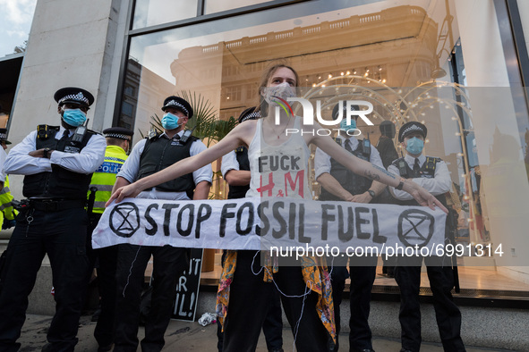 LONDON, UNITED KINGDOM - AUGUST 24, 2021: An environmental activist from Extinction Rebellion protests outside Selfridges department store i...