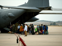 Afghan refugee queue to embark into a US air force plane at Torrejon Military Air Base in Madrid, Spain on 24th August, 2021. (