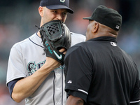 Seattle Mariners starting pitcher J.A. Happ talks to home plate umpire Las Diaz after the second inning of a baseball game against the Detro...