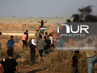 Palestinian demonstrators gather at the Israel-Gaza border fence during a protest in the southern Gaza Strip August 25, 2021. 
 (