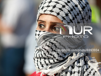 A Palestinian demonstrator gather at the Israel-Gaza border fence during a protest in the southern Gaza Strip August 25, 2021. 
 (