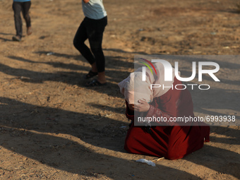 Palestinian protesters carry a wounded young man during a protest in the southern Gaza Strip August 25, 2021. 
 (