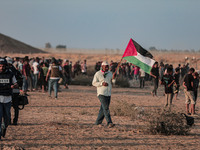 Palestinian protesters gather during the clashes near the border between Israel and Gaza Strip, in the eastern Khan Younis town southern Gaz...