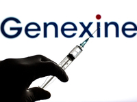 In this photo illustration, a close up of a hand holding a medical syringe in front of the Genexine, Inc. logo (