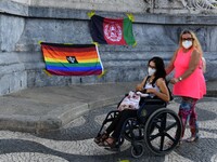 Two women walk near several flags during a rally in favor of the women of Afghanistan, held at Rossio Square, Lisbon, Portugal on August 27,...