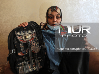 The mother of Palestinian teen Omar Abu Neal displays his school clothes , who died of a wound he sustained during an anti-Israel protest at...