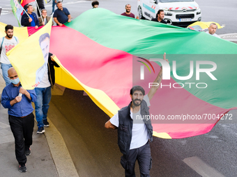 Kurdish demonstrators carry a long flag in the colors of Kurdistan in Paris, France, on August 28, 2021. As the French and Iraqi presidents...