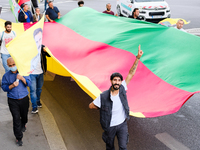 Kurdish demonstrators carry a long flag in the colors of Kurdistan in Paris, France, on August 28, 2021. As the French and Iraqi presidents...