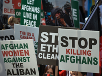Members of the local Afghan diaspora, activists and local supporters seen in front of the Alberta Legislature Building during the STOP KILLI...