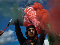 Protester lights a flare in the colors of Afghanistan.
Members of the local Afghan diaspora, activists and local supporters seen in front of...