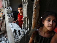 Palestinian children inspect their home damaged in a nearby Israel bombing at Hamas sites over fire balloons into Israel, in Beit Hanoun in...