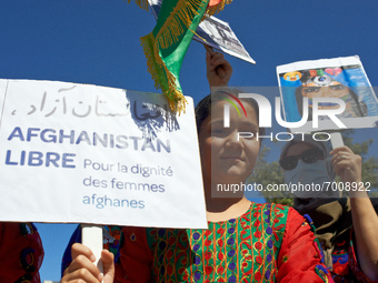 A young girl in traditionnal dress holds a placard reading 'Free Afghanistan. For the dignity of women'.  Dozens of members of the Afghani c...