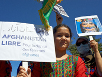 A young girl in traditionnal dress holds a placard reading 'Free Afghanistan. For the dignity of women'.  Dozens of members of the Afghani c...