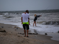 People enjoy the beach before remnants of Hurrican Ida hit Cape May Point, New Jersey, the southern-most tip of the state on September 1, 20...