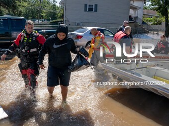 Members of the Lodi, New Jersey Fire Department perform water rescues of trapped residents following torrential rains from the remannts of H...