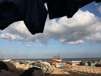 Palestinian fishermen work along a beach in Khan Yunis, southern Gaza Strip, on September 6, 2021.
 (
