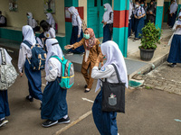 Children leave school after they finish studying, in South Tangerang, Indonesia, on September 6, 2021. Indonesia government eased the Covid-...