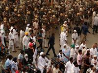 Farmers participate in a protest march as part of a farmers' protest against farm laws during a meeting at Karnal in the northern state of H...