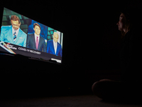 A woman watches the official televised Federal election leaders' debate at her home in Edmonton.
Five federal leaders take part in the Engli...