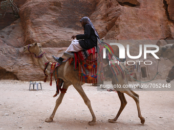 A Bedouin guide rides a camel through the ancient city of Petra. Jordan, Friday, September 10, 2021 (