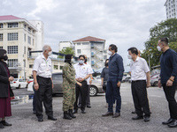 Malaysian Health Minister Khairy Jamaluddin (three from right) talks to army personnel at Penang Hospital in his first official working visi...