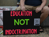 An activist holds a placard with words 'Education Not Discrimination.'
Activists and members of the Albertans for a Quality Curriculum group...