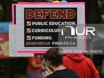 An activist holds a placard with words 'Defend Public Education, Curriculum, Funding'.
Activists and members of the Albertans for a Quality...