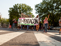 Protesters march through downtown during an event launching a campaign by CODEPINK to cut the Pentagon’s budget and military spending and us...