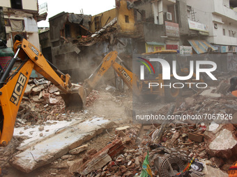 Rescue workers remove debris to search for survivors after a four-storey building collapsed near Subzi Mandi area, in New Delhi, India on Se...