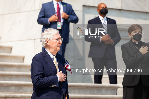 Senate Minority Leader Mitch McConnell (R-KY) listensw to the national anthem with hand over heart during a ceremony in the Capitol steps in...