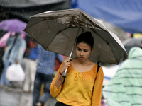A girl with an umbrella ca be seen during heavy rainfall in Kolkata, India, 14 September, 2021.   (
