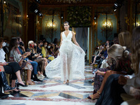 A model walks the Atelier Couture catwalk with a design from the De La Cierva & Nicolas bridal collection during Madrid Fashion Week in Madr...