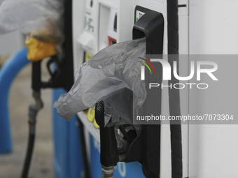 Gas pumps are covered with plastic bags to indicate the pumps have been turned off in Galveston, Texas on September 14th, 2021.  (