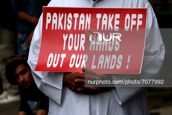 An Afghan national holds a placard during a protest against Pakistan's alleged support to the Taliban, in New Delhi, India on September 16,...