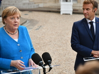 German Chancellor Angela Merkel  and French President Emmanuel Macron speak to the press at the Presidential Elysee Palace  for a meeting an...