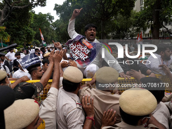 An activist of the Indian Youth Congress (IYC) party shouts slogans as he takes part in a protest against the rising unemployment while mark...