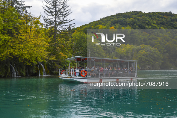 Tourits swim on a boat on Plitvice Lakes in National Park in Croatia on September 15, 2021. In 1979, Plitvice Lakes National Park was inscri...
