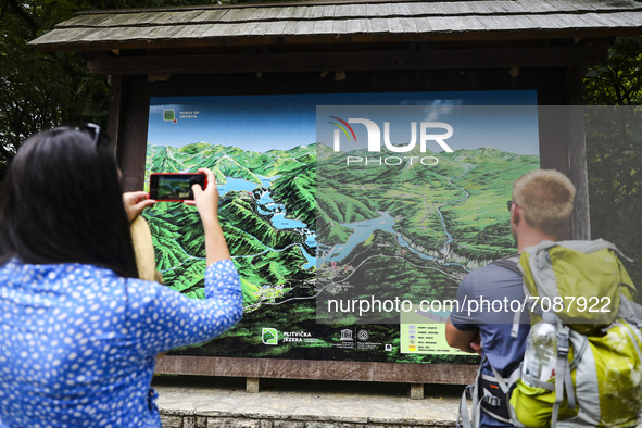 Tourist take pictures of a map of waterfalls at Plitvice Lakes National Park in Croatia on September 15, 2021. In 1979, Plitvice Lakes Natio...