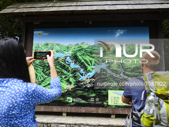 Tourist take pictures of a map of waterfalls at Plitvice Lakes National Park in Croatia on September 15, 2021. In 1979, Plitvice Lakes Natio...