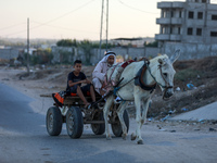 Palestinians ride a donkey-drawn cart in the northern Gaza Strip, on September 19, 2021.
 (